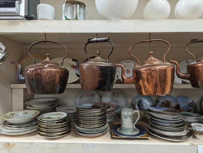 Antique Teapots and saucers on shelves