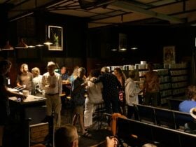 people enjoying food and socialising at tables