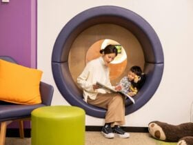 Woman with her son reading a book in a circular nook.