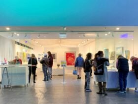 entrance of gallery space with people & blue lighting