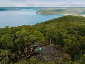 Aerial view of hikers along Warrah Trig walking track framed by the picturesque Hawkesbury River.