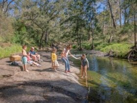 A family enjoying the Washpools waterhole along the Middle Brook. Credit: John Spencer © DPE