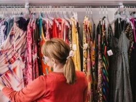 Image of a lady looking at op shop items on a clothing rack