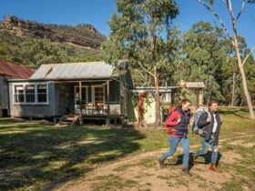 A couple hiking from Slippery Norris Cottage in Yerranderie Private Town, Yerranderie Regional Park.
