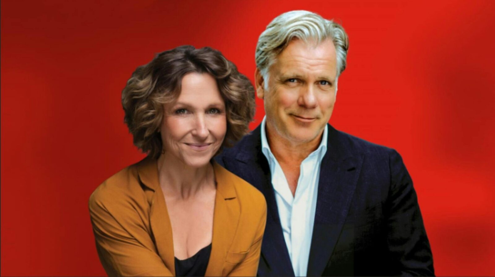 A woman in an orange blazer and a man in a navy suit pose together against a vibrant red background,