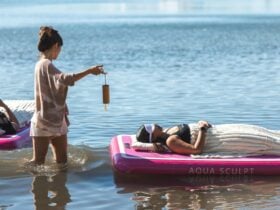 Lady lying on floating board listening to soundscapes