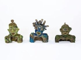 Three ceramic sculptural figures arranged side by side on a white background.