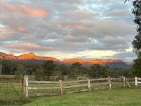 Capertee Mountain range with pink orange glow at sunset