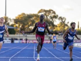 Gout Gout crossing the finish line celebrating in the 100m race