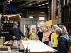Group of people on a behind the scenes tour being shown a special item
