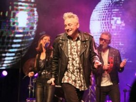 The Countdown team standing on stage performing