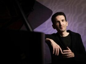 Internationally acclaimed pianist Emmanuel Despax sits by the piano