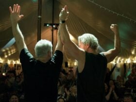 two male performers taking a bow to the crowd