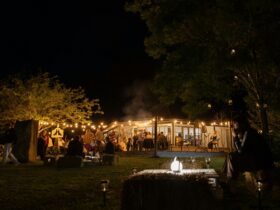 People enjoying wine, fire and live music at an event opening
