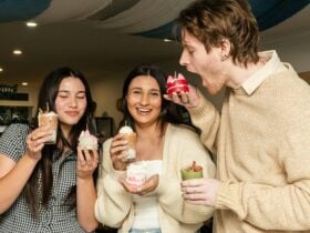 Three participants holding their handmade dessert candles and pretending to eat them