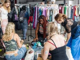 people rummaging through clothing sale bins
