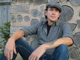 Joe H Henry sitting by a stone wall