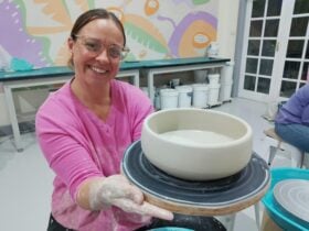 a person is holding a pottery piece that they made on the pottery wheel