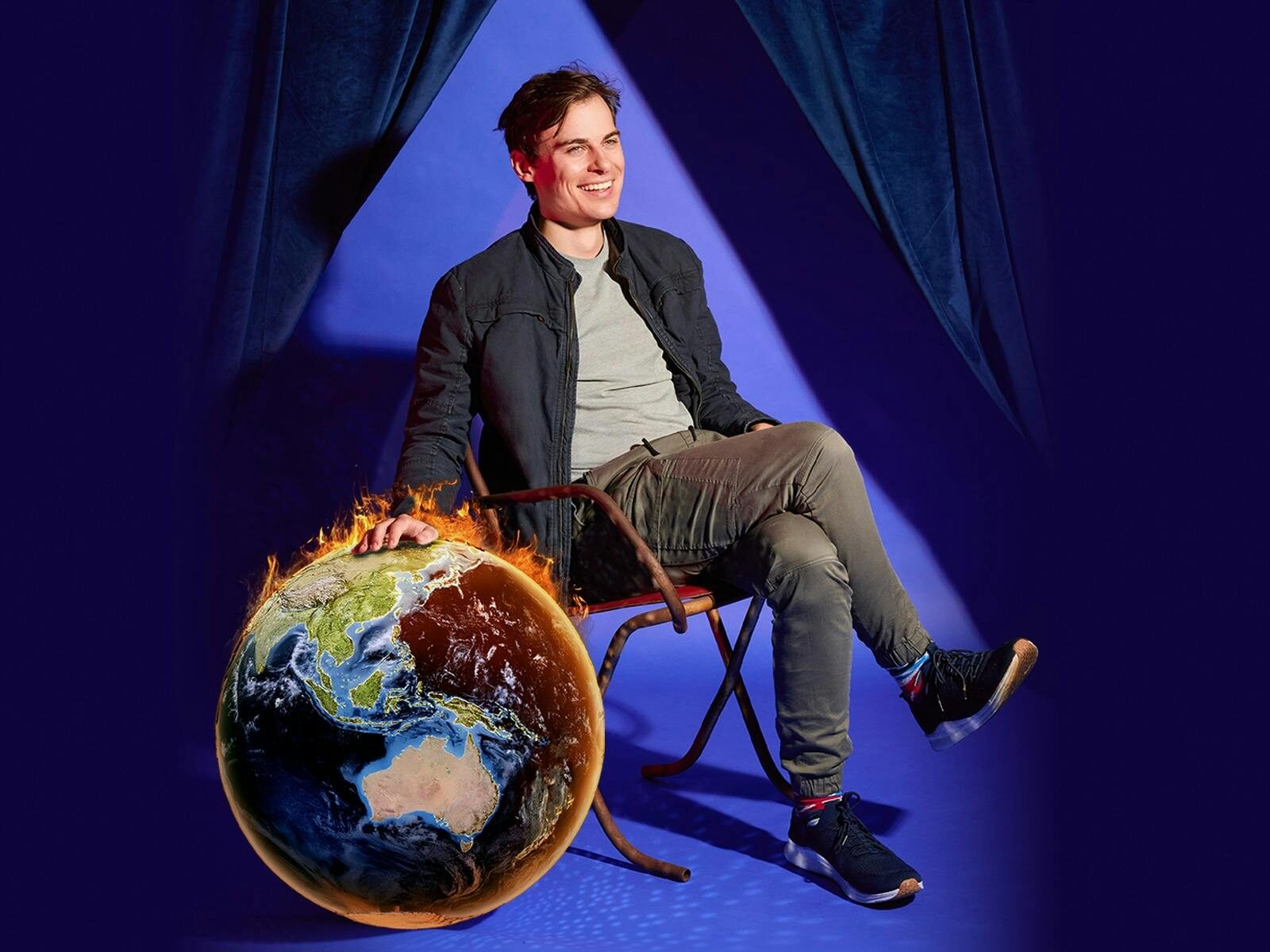 Man sitting on chair and a world