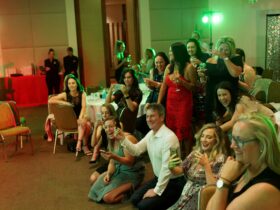 a group of people laughing at the hypnosis act