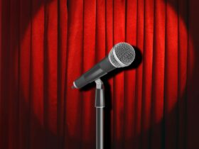 Microphone in front of a stage curtain with a stage spotlight on it