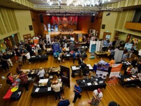 Wollongong Town Hall filled with Aboriginal business stallholders with tables and community members
