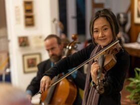 Female musician playing violin and a male musician playing the cello