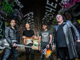 Image of four men with guitars