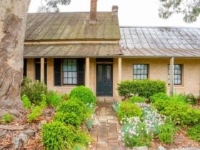 Sandstone building with path leading to the front door.