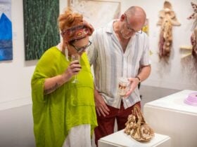 People looking at artwork in an exhibition at the Museum of Art and Culture Lake Macquarie