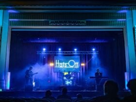 an image of Hats Off closing the 2025 show. Soft blue lighting through a smoke haze