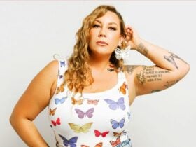 Woman with long blonde hair wearing a singlet with butterflies