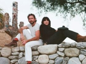 Man & Woman sitting on rock wall