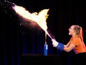 Questacon presenter shoots a large fireball from a squeeze bottle.