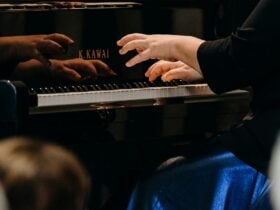 the pianists hands are reflected on the kawai piano