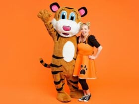 A photo of Pevan & Sarah on an orange background