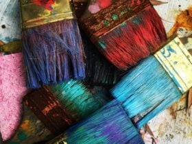 Photo of paint brushes with bright paint on the bristles