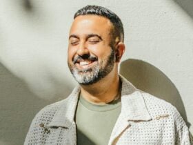 Male smiling with their eyes closed.