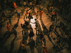 Birds eye view of people dancing on wooden floors, doing salsa and other latin dances.