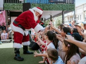Santa greeting visitors at Santa