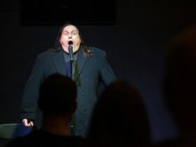 Comedian Scotty Boom Booms caught in a hilarious pose on stage