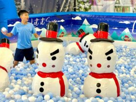 Child playing in ball pit with snowmen