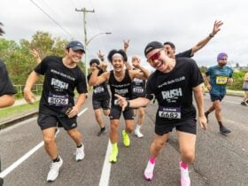 Runners smile at camera
