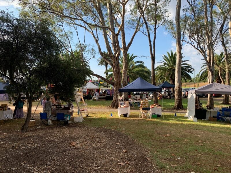 Several stalls under tall gum trees