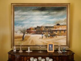 A large Australiana painting hugs above an antique dresser
