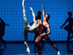 Two dancers on a blue background