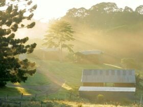 Sunset on a beautiful farm with cabin accomodation in the background