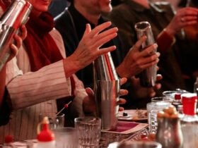 Class attenders shake cocktails