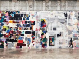 A wall covered in knitted patches of textiles