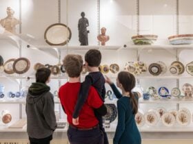 A family in front of a display case with old objects
